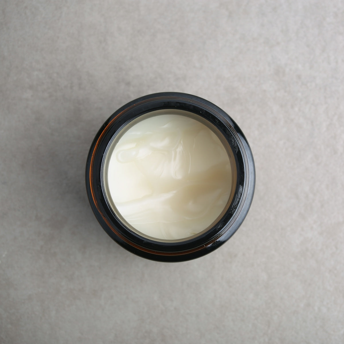 a jar of cream sitting on top of a table