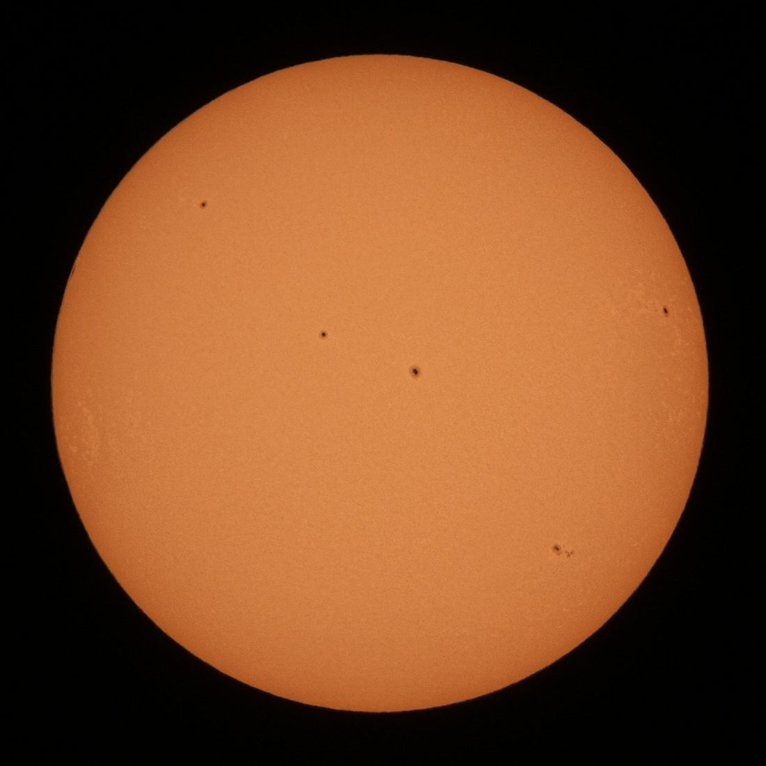 a very large orange sun in the dark sky